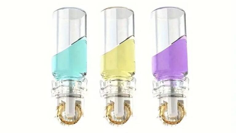 Three Hydra.Roller MicroNeedle Systems with colorful liquids in glass vials.