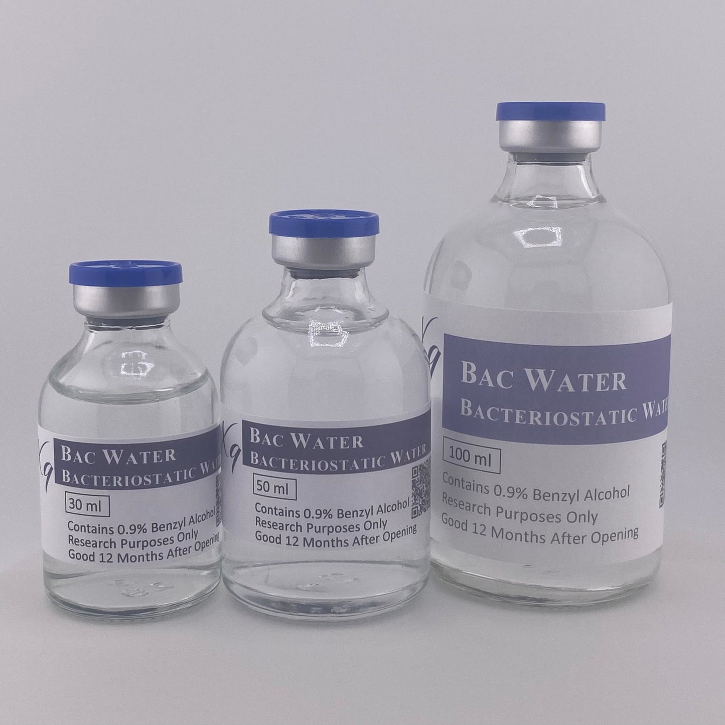 Three clear glass vials of Bacteriostatic Water, 30ml, 50ml, and 100ml, with blue caps.