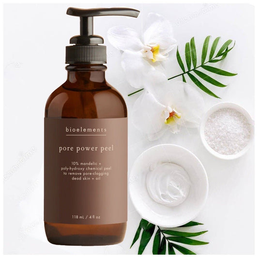 A brown pump bottle of Bioelements Pore Power Peel with white orchids and green leaves.
