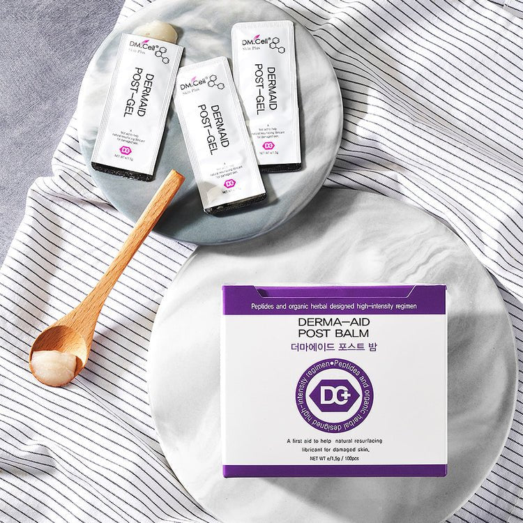 Three white sachets of DM.Cell Dermaid Post-Gel and a purple and white box of Derma-Aid Post Balm.