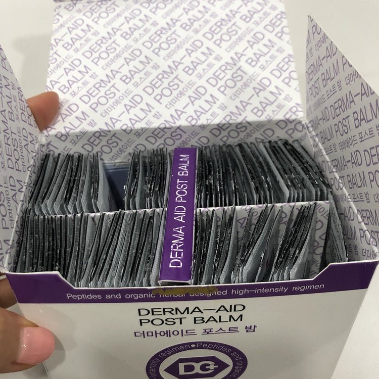 A white box of DM. Cell Skin Plus Derma-Aid Post Balm sachets, with one sachet pulled out.