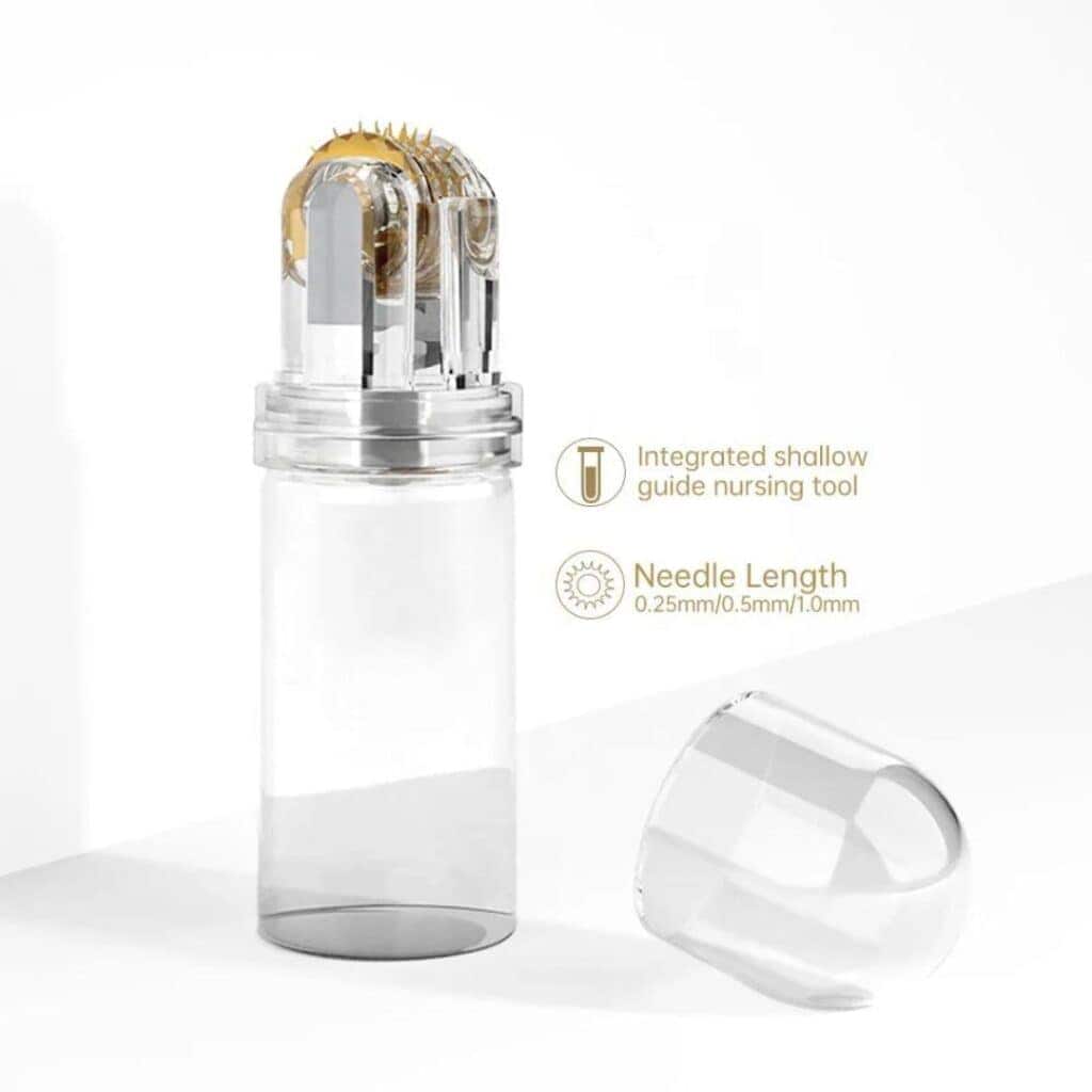 A clear glass microneedle system with a gold and clear roller head and a separate cap.