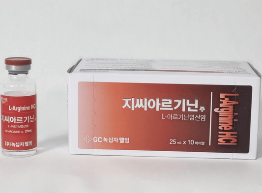 A vial and a box of L-Arginine HCl, a clear liquid in a glass container with a red cap.