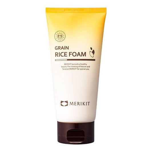 A yellow and white tube of MERIKIT Grain Rice Foam facial cleanser with a brown cap.