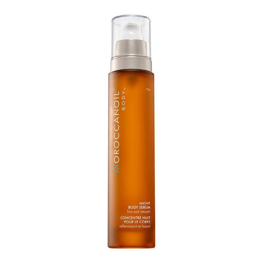 MoroccanOil Night Body Serum in an amber pump bottle with a clear cap.
